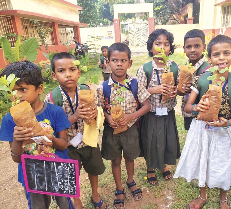 School children with saplings during an Adani Foundation plantation drive