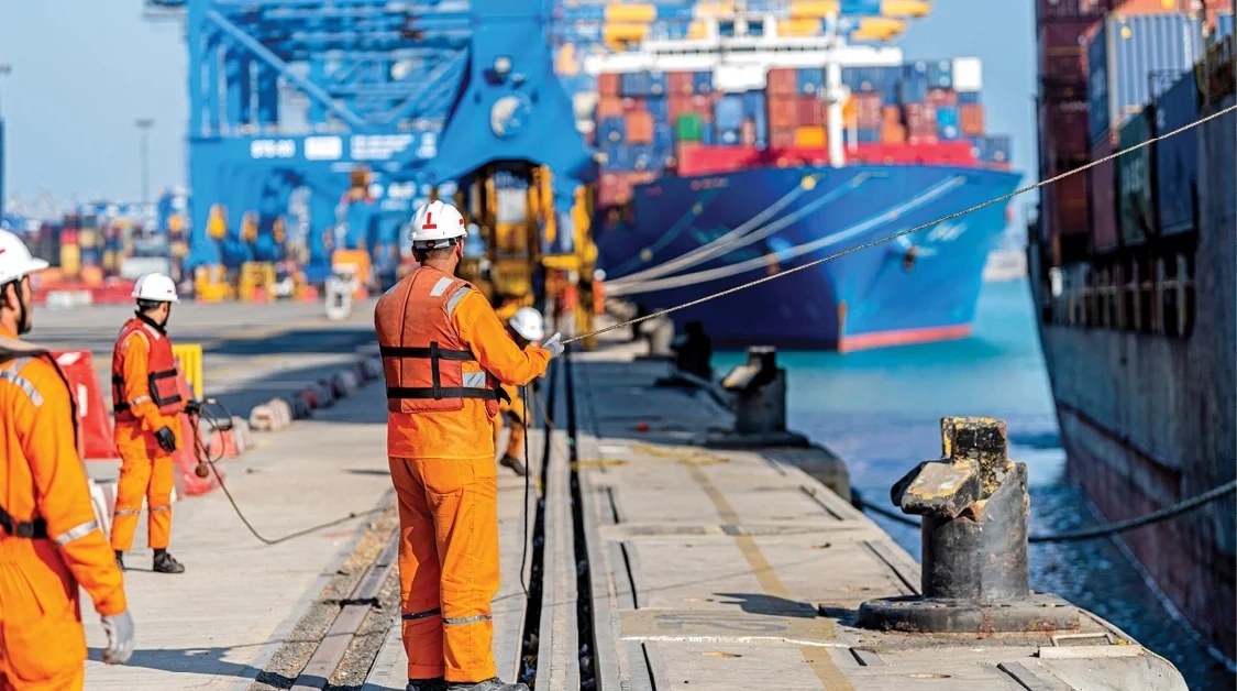APSEZ port workers mooring a container vessel