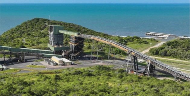 Aerial view of a conveyor and cargo-handling facility beside the coast