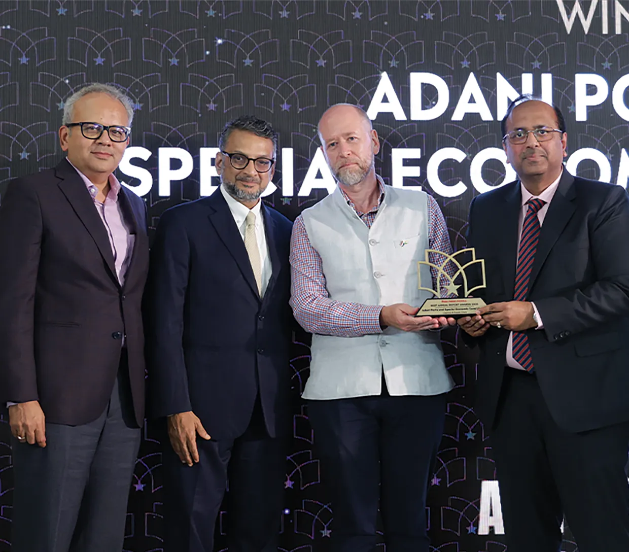 APSEZ leaders receiving an award on stage